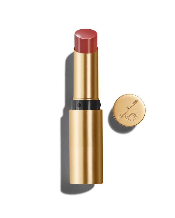 Baume Embrace in Epanoui, a mauve pink lip colour with a gold-colored casing, next to the Lisa Eldridge logo-embossed lid