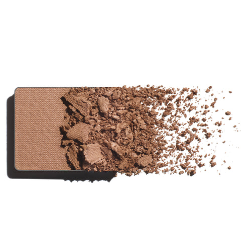 Makeup eyeshadow refill with taupe powder on a white background